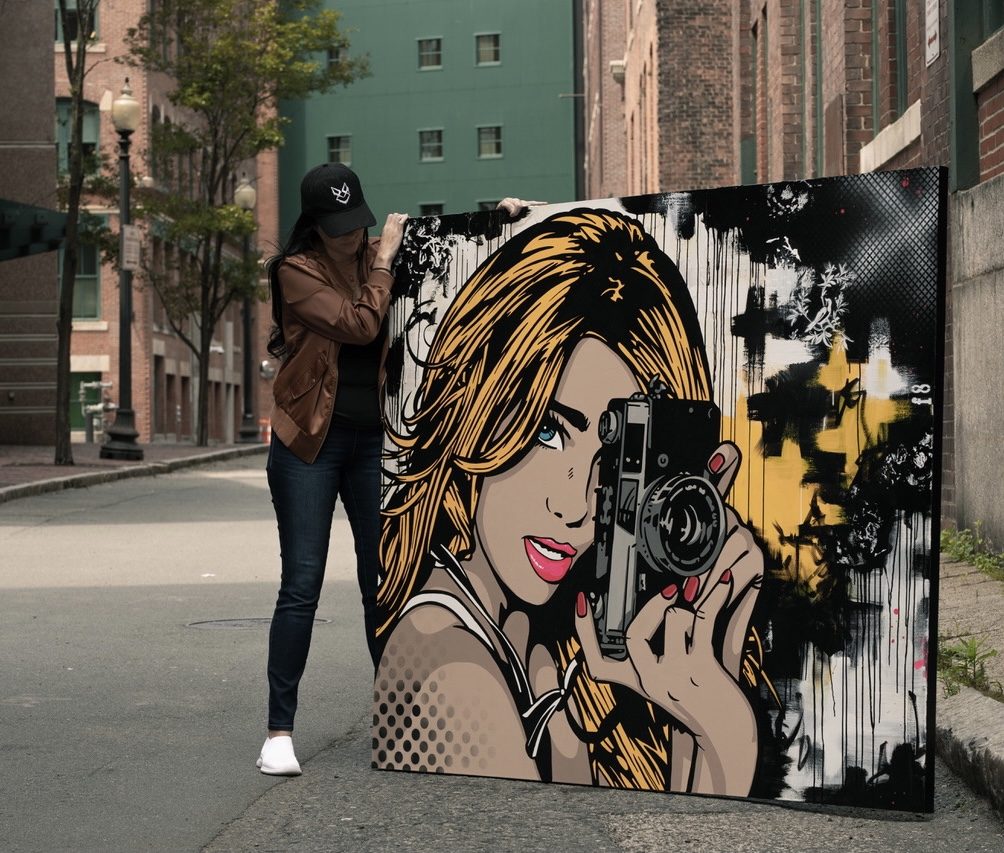 Erica Hagler, Blind Fox, carrying a pop art painting on a Boston street