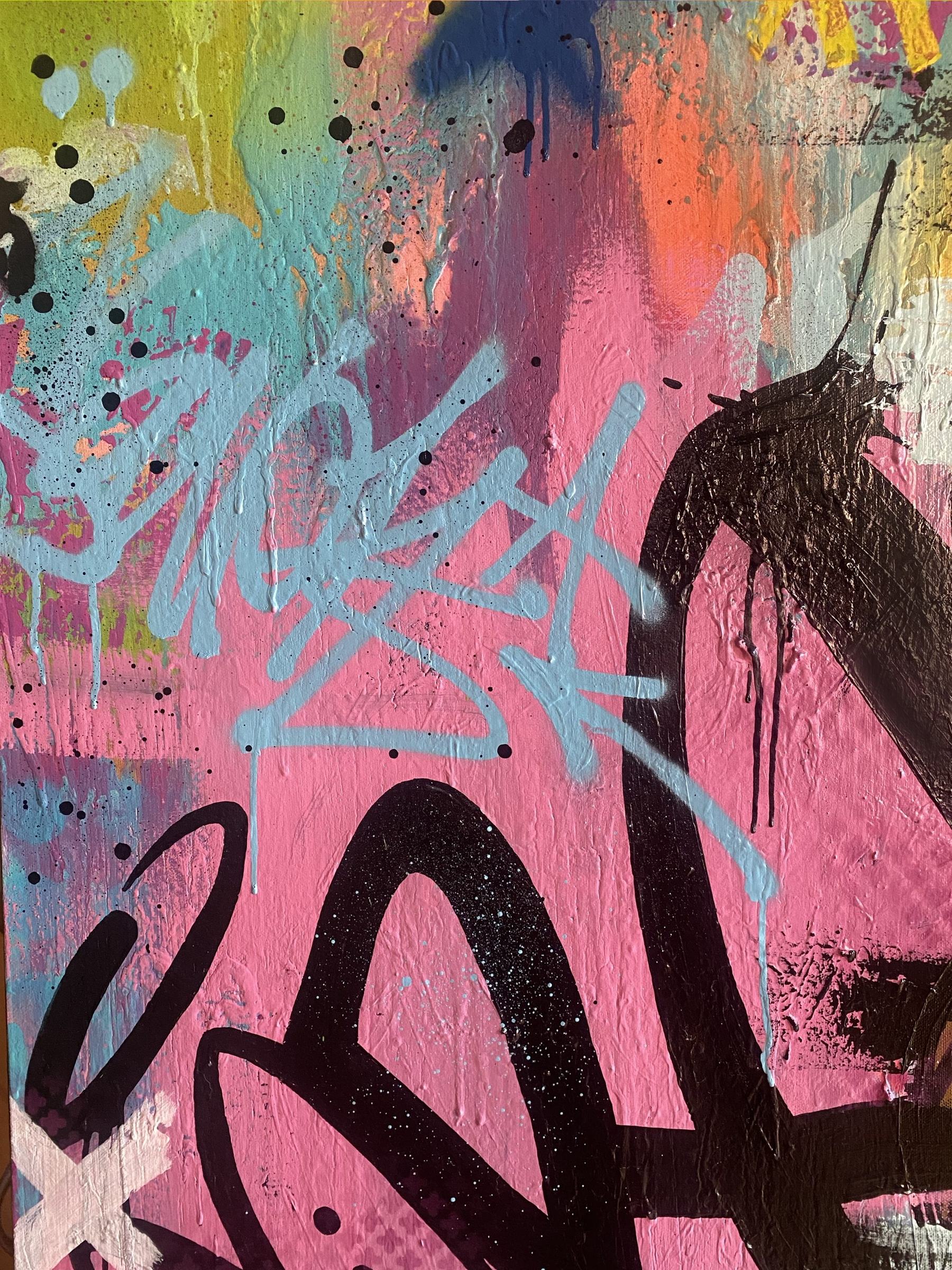 Detail of a colorful graffiti-style painting in pink, black, teal and yellow, hanging in VANDL gallery